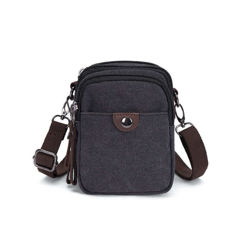 Canvas small crossbody bag with brown strap.