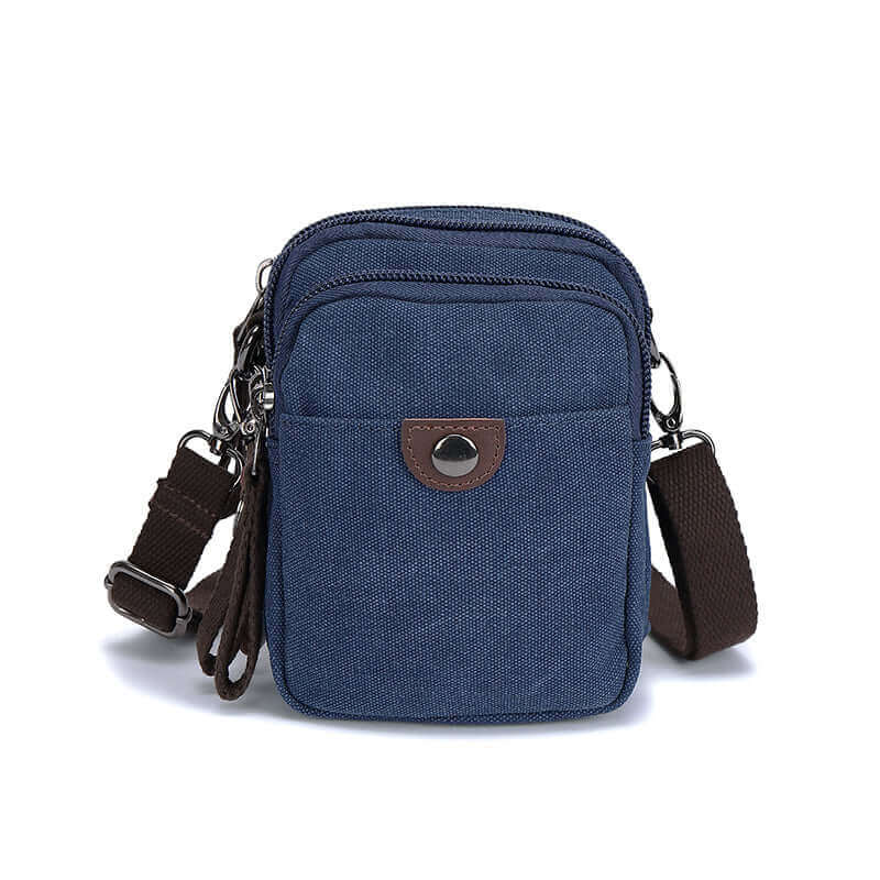 Front view of the blue canvas small crossbody bag with waist clip.