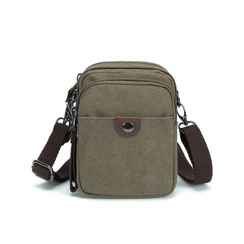 Green canvas small crossbody bag with waist clip and carabiner.