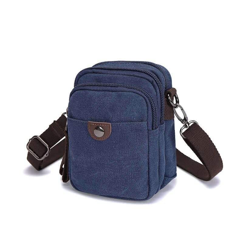 Blue canvas small crossbody bag with brown strap.