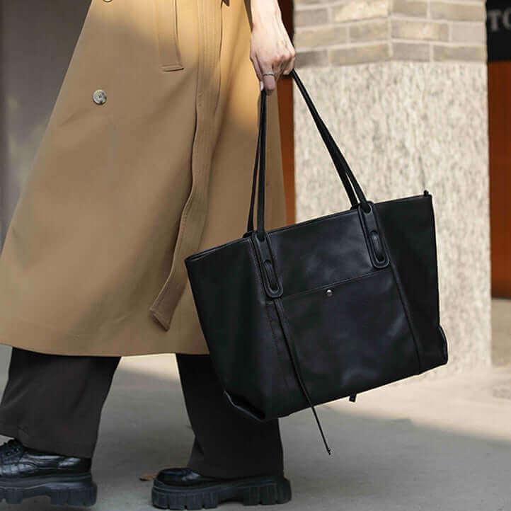 Stylish black leather tote bag with a chic minimalist design, ideal for commuting.