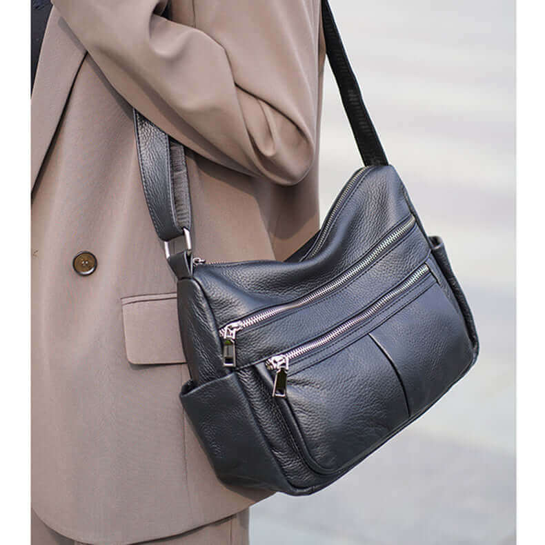 Soft leather crossbody bag with adjustable shoulder strap, perfect for casual and formal use.