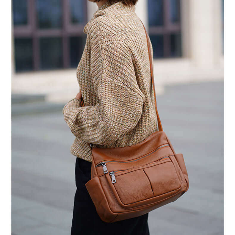 Women's brown crossbody bag crafted from soft, premium leather with a minimalist design.