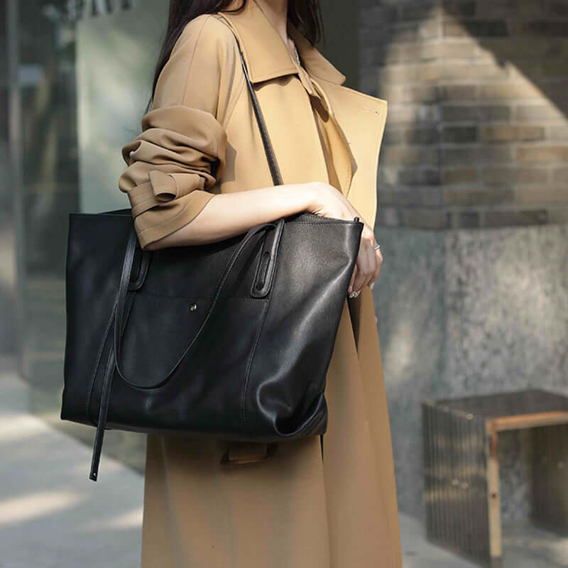 Women’s large leather tote bag in black, featuring a spacious interior for organization.