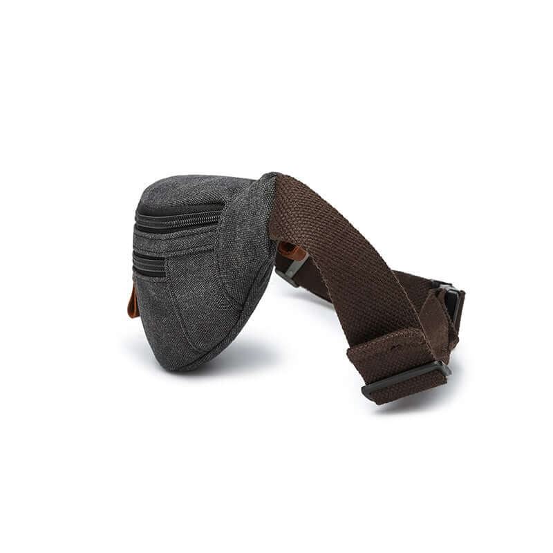 Side profile of vintage black canvas bum bag with leather pulls