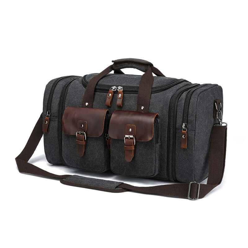 Black canvas travel bag with top handles and leather buckles