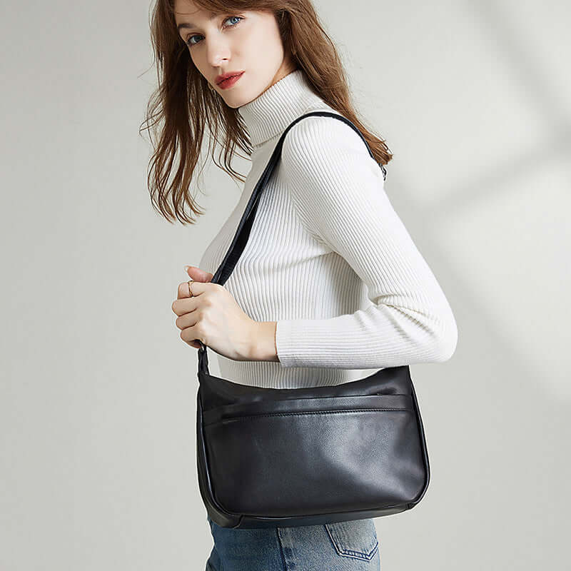 Woman wearing black leather crossbody bag