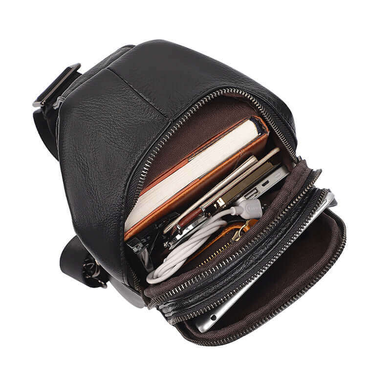 Professional storage compartments inside a men's black leather sling bag.