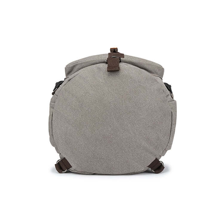 Bottom view of cylindrical-shaped grey travel backpack