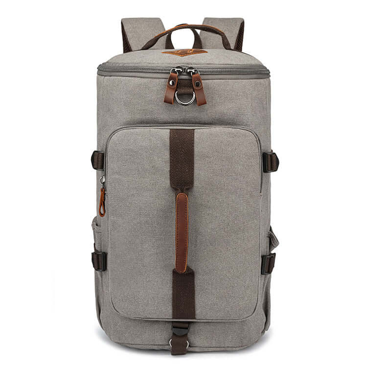 Canvas backpack standing upright with full zip closure