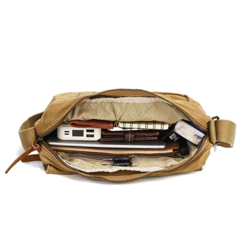 Open view of the canvas crossbody bag showcasing compartments