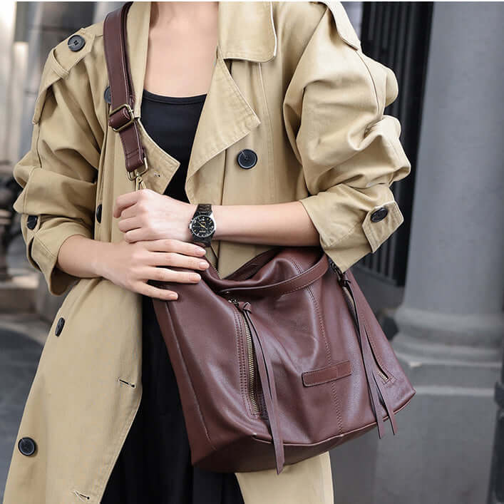 Woman wearing coffee brown leather tote crossbody style