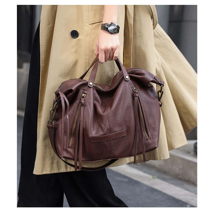 Coffee brown leather handbag carried by hand