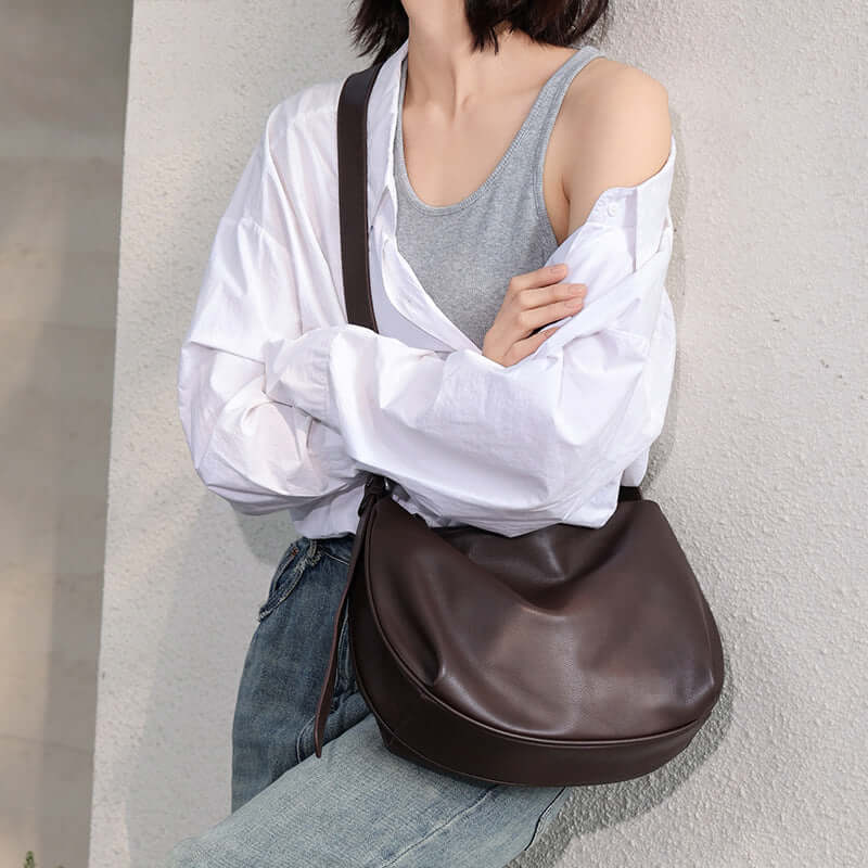 Coffee leather bag styled as a shoulder bag.