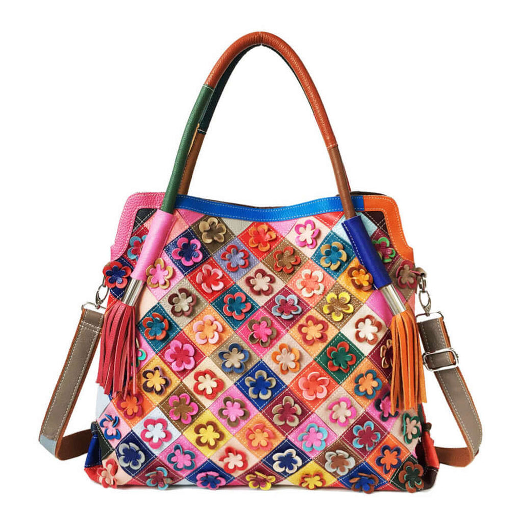 Front view of colorful leather tote bag with floral patchwork design.