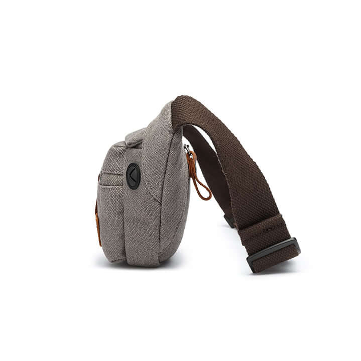 Side view of slim canvas bum bag with brown strap