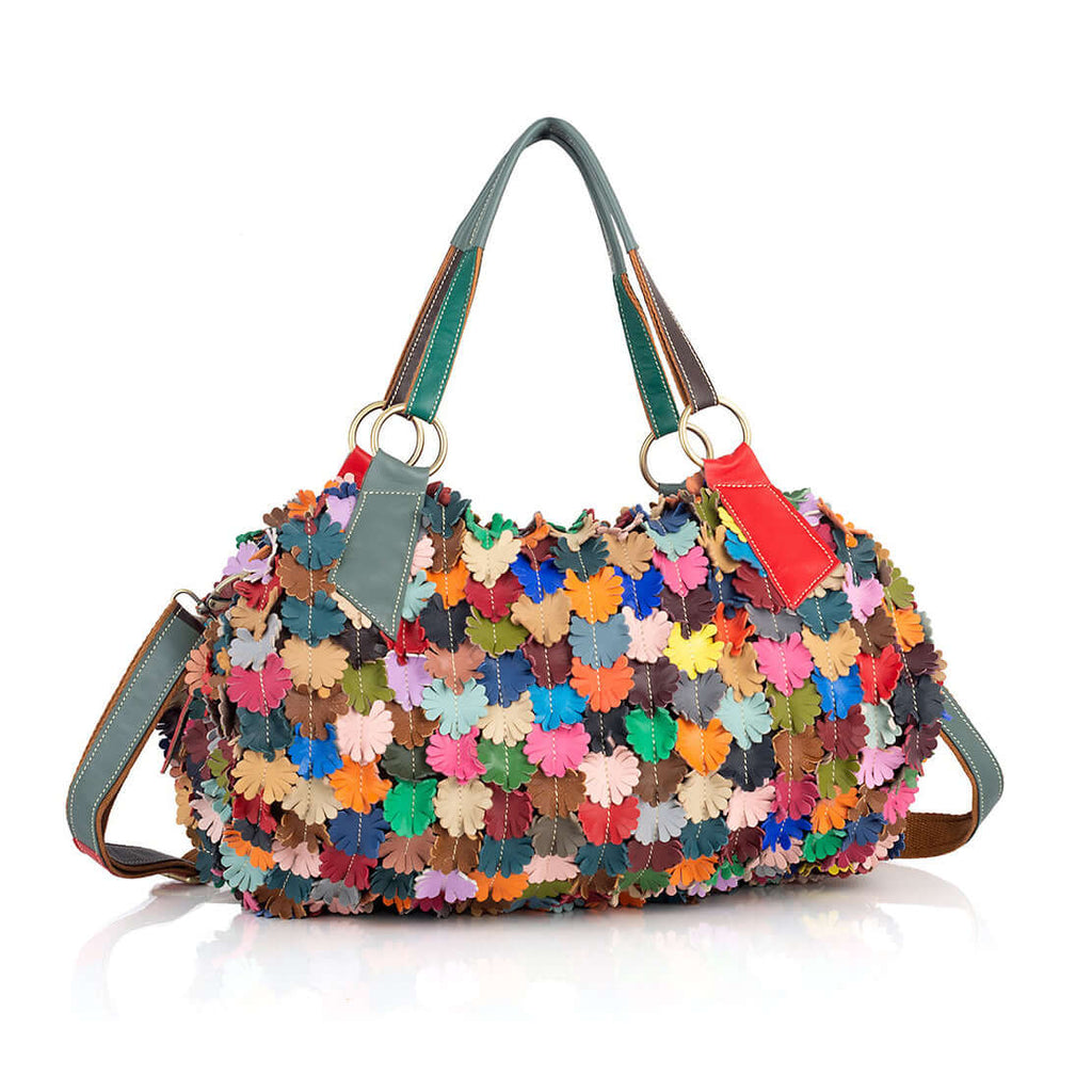 Colorful leather floral tote bag carried by hand.