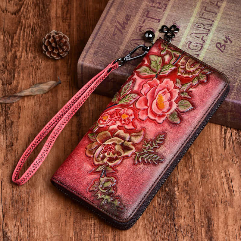 Model holding embossed leather wallet with wristlet