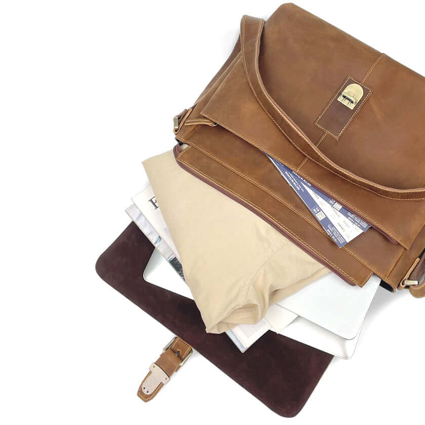 Inside compartments of leather messenger bag with organized layout.