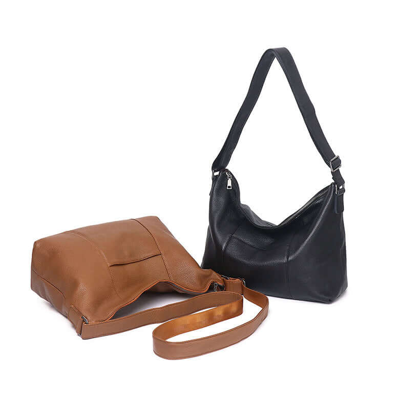 Women's leather bag worn as a crossbody.