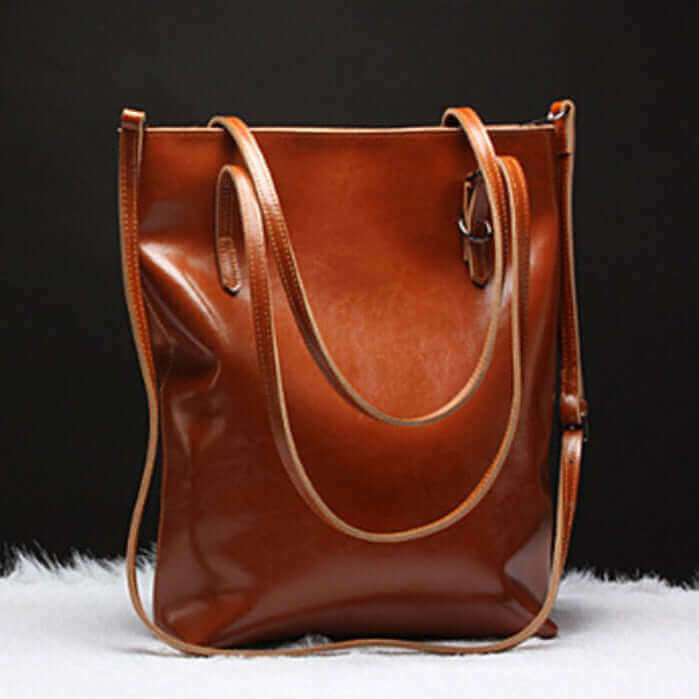 Leather tote bag worn as a crossbody bag