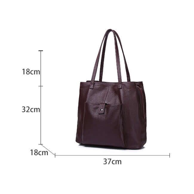 Inside view showing capacity of leather tote bag with MacBook and daily essentials