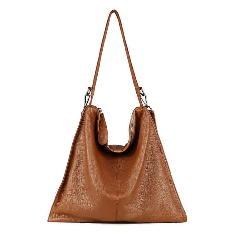 Women's leather tote bag worn over the shoulder.