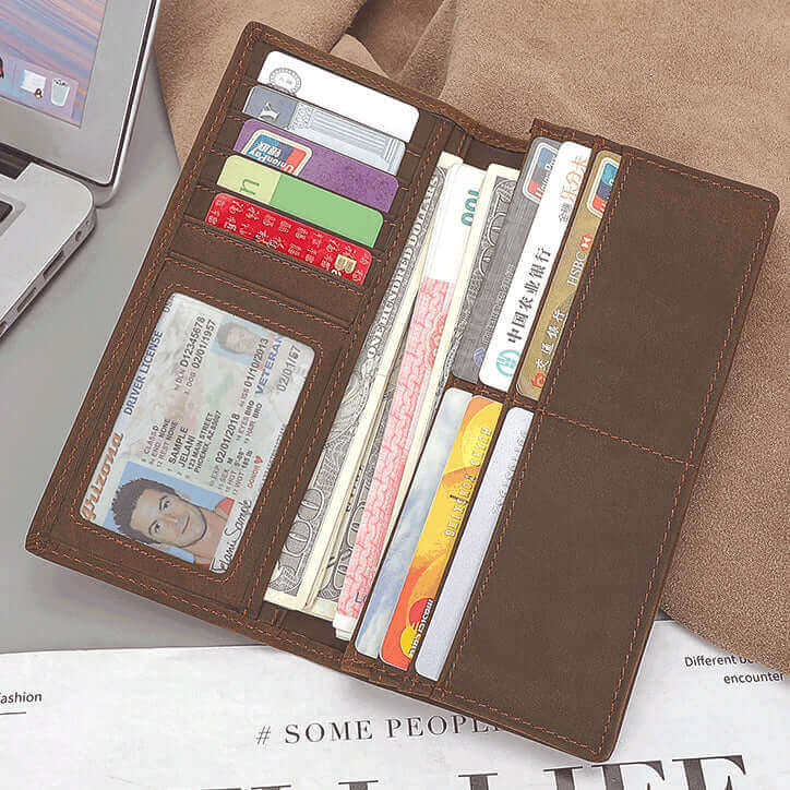 Interior of brown leather long wallet showing cards, cash, and ID holder.