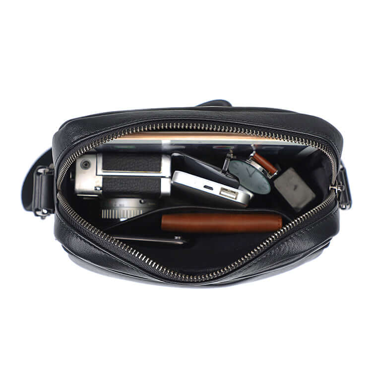 Interior view of the men's black leather crossbody bag with practical compartments.