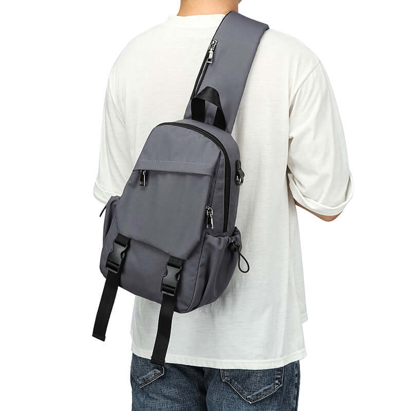 Back view of the waterproof sling bag worn by a model.