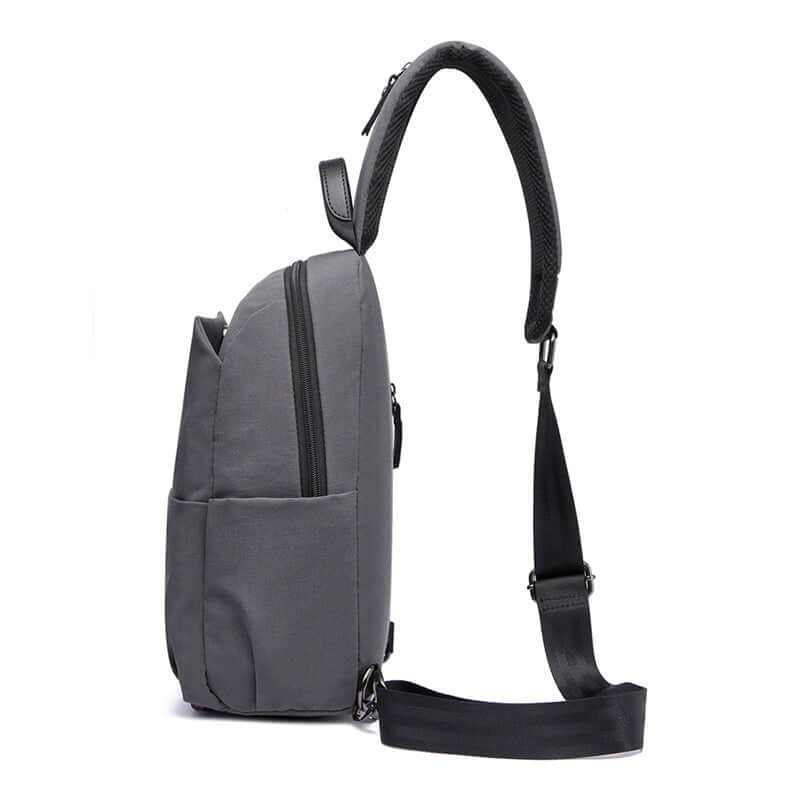 Side view of men’s grey sling chest bag with waterproof finish