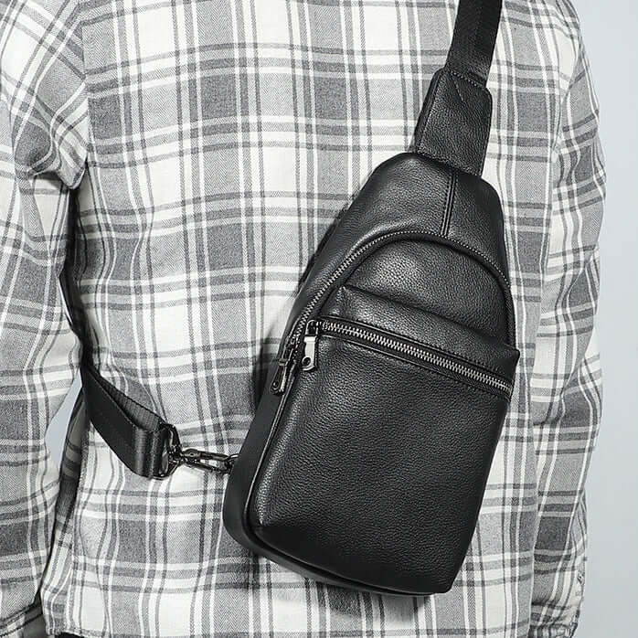 Minimalist and modern black leather chest bag for men.