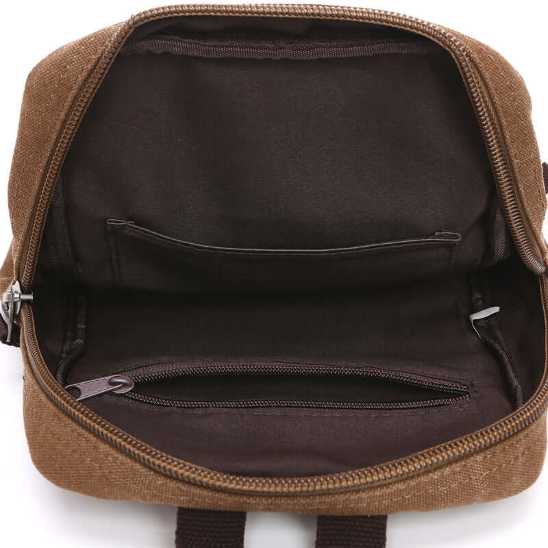 Opened canvas crossbody sling bag showing interior space