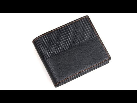 Close-up of embossed pattern on black leather wallet