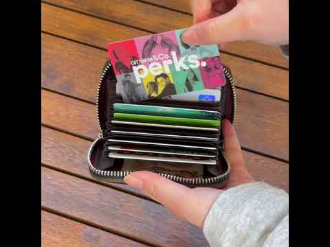 Secure RFID leather card holder with colorful woven edges, featuring space for 12 cards, coins, and IDs.