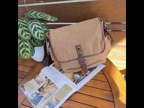 Casual canvas shoulder bag with large capacity and stylish buckle closure.