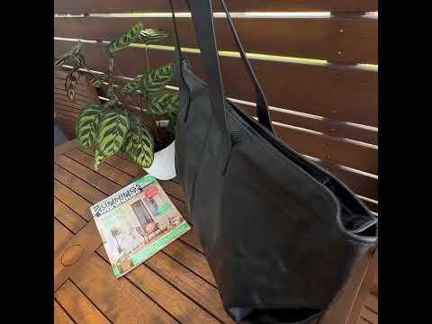 Interior of the black leather tote bag showing spacious compartments