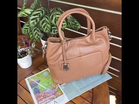 Versatile design of leather handbag for multiple carrying styles.