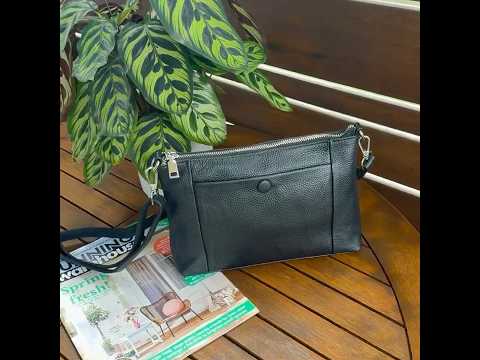 Women's black leather crossbody bag front view showcasing stylish and compact design.