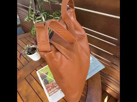 Leather tote bag with adjustable shoulder strap.