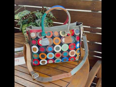 Versatile colorful leather handbag with multiple straps.