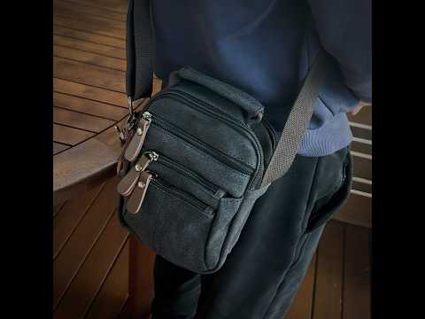 Stylish black canvas shoulder bag with multiple zippered pockets for daily essentials.