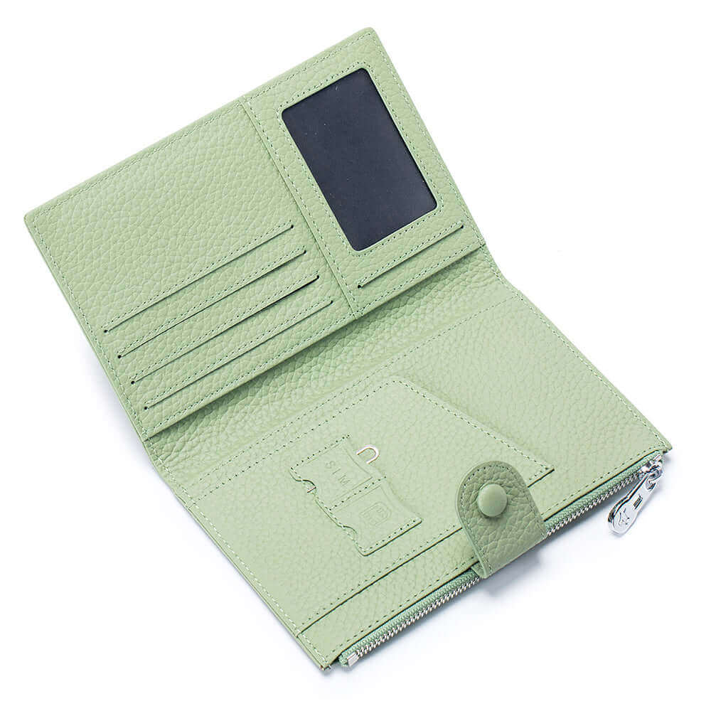 Green RFID-protected leather passport wallet with multiple compartments open to show contents.