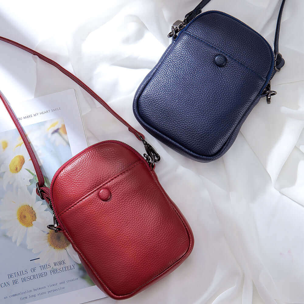 Stylish women's leather mini phone bag with functional compartments and magnetic buckle closures.