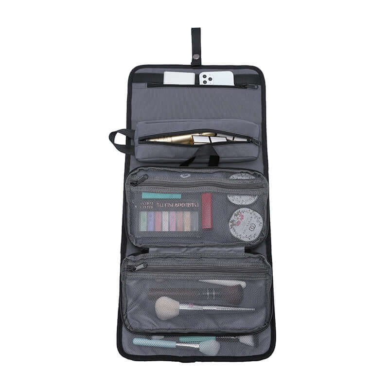 Open view of toiletry bag with multiple compartments filled with cosmetics