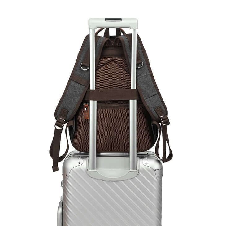 Back of canvas backpack showing luggage strap for airport travel