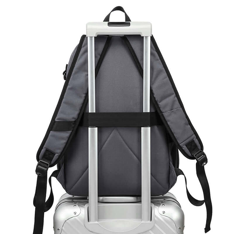 Backpack with luggage strap mounted on suitcase for easy travel