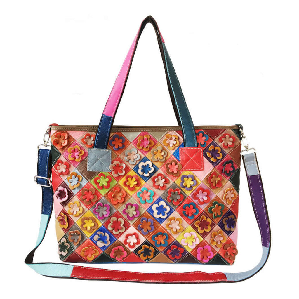 Front view of a colorful leather tote bag with a unique flower patchwork design