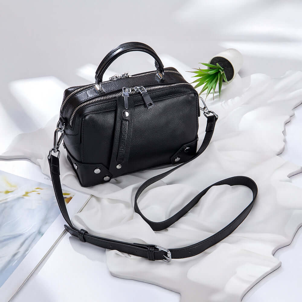 Luxury black leather handbag with detachable strap.