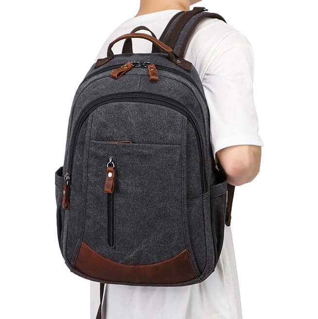 Vintage canvas backpack worn by model for school and work
